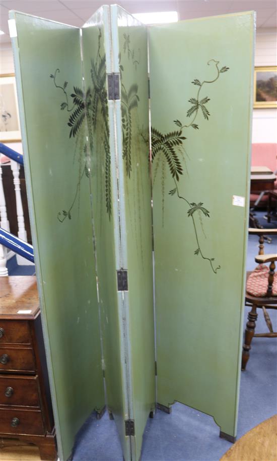 An Eastern green painted leather four fold dressing screen, decorated with bamboo, pine trees and wisteria, each panel W.46cm H.184cm